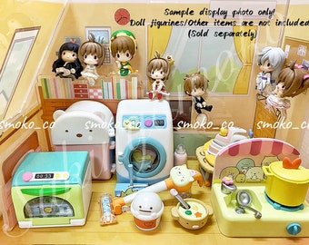 May include: A display of miniature dollhouse furniture and figurines. The set includes a washing machine, oven, stove, and various figurines. The text "Sample display photo only! Doll figurines/Other items are not included (Sold separately)" is visible.