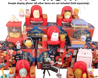May include: A set of miniature movie theater themed toys, including a popcorn machine, ticket booth, and red plush seats. The set features characters from the popular Japanese cartoon "Sumikko Gurashi".