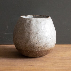 Hand-built 8oz cup, textured clay and white glaze. Good for cappuccino, flat white, coffee, and tea.