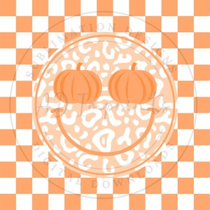 May include: A white and orange checkered background with a white circle containing a leopard print pattern. Two orange pumpkins are inside the circle, forming a smiley face.
