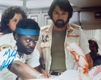 May include: A scene from the movie Alien with three crew members. One crew member is wearing a white shirt with a blue headband and has a beard. Another crew member is wearing a white shirt with a brown vest and has a beard. The third crew member is wearing a white shirt and has a bandage on their arm.