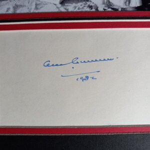 May include: A white card with a blue ink signature that reads "Cesar Chavez" and the year "'62" underneath.