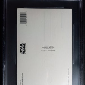 May include: A white postcard with a black and white image of Obi-Wan Kenobi from Star Wars: A New Hope. The back of the postcard has copyright information and the text "Made in the USA".