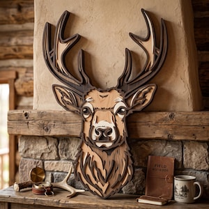 May include: A multi-layered wooden wall art piece shaped like a deer head with intricate cutouts. The design features varying shades of natural wood, from light tan to dark brown, creating a dimensional effect with detailed antlers and facial features.
