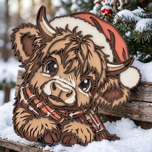 May include: A multi-layered wooden wall art piece depicting a Highland cow wearing a red and white Santa hat and a red plaid scarf. The design features intricate laser-cut details in various shades of brown, cream, and red wood tones.