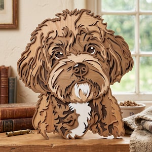 May include: A multi-layered wooden wall art piece shaped like a dog head with curly fur. The design features various shades of brown, tan, and white wood, creating a dimensional effect with detailed cutouts for the eyes, nose, and mouth area.