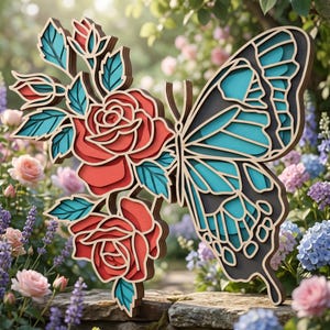 May include: A multi-layered wooden wall art piece featuring a butterfly on the right side and two roses with leaves on the left. The design uses a color palette of red, teal, and dark brown, with visible stacked layers creating a dimensional effect.