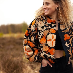 Black embroidered bomber  jacket, inspired by Uzbekistani suzani art. Crafted from thick woven cotton with intricate floral & leaves embroidery symbols. Style it cropped for a puff effect.