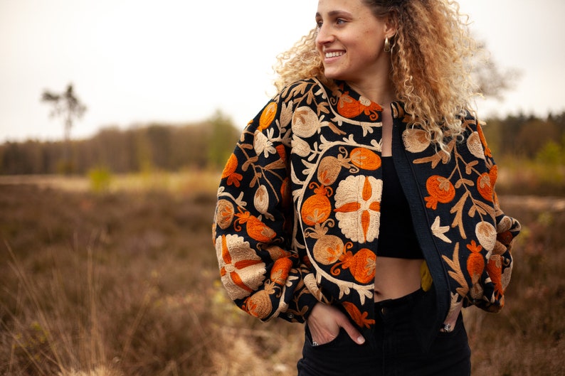 Black embroidered bomber  jacket, inspired by Uzbekistani suzani art. Crafted from thick woven cotton with intricate floral & leaves embroidery symbols. Style it cropped for a puff effect.