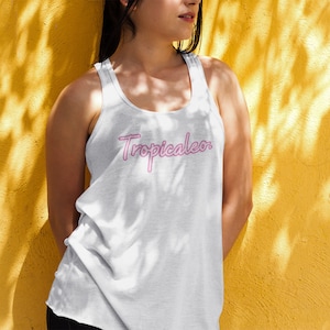 May include: A white tank top with a pink neon sign-style graphic that says "Tropicaleo."