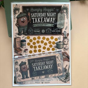 May include: A Hungry Haggis Saturday Night Takeaway scratch-off card featuring a cartoon character in a plaid hat and trousers, a chalkboard design with text, gold scratch circles, and illustrations of kitchen items, plus a matching clear plastic pouch.