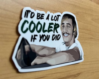 May include: A white sticker with a cartoon illustration of a man with blonde hair and a mustache. The man is wearing a white shirt and has a serious expression on his face. The text on the sticker reads "It'd be a lot cooler if you did."
