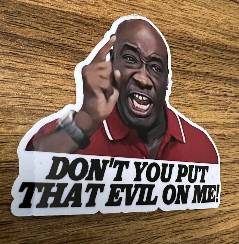 May include: A sticker featuring a man with a serious expression, pointing his finger and saying "Don't you put that evil on me!"