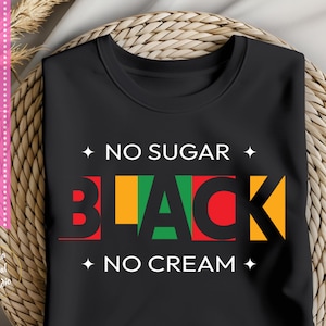 May include: Black t-shirt with the text "No Sugar No Cream" and the word "Black" in red, yellow, green, and black letters.