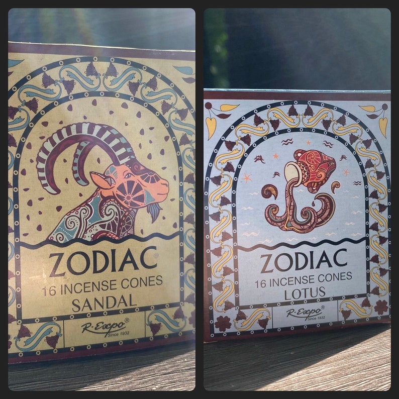 May include: Two boxes of incense cones with zodiac signs. The left box features a goat with the text "Zodiac 16 Incense Cones Sandal R.Exxpo Since 1932". The right box features a water sign with the text "Zodiac 16 Incense Cones Lotus R.Exxpo Since 1932".