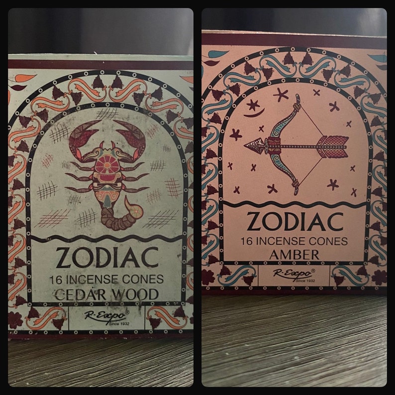 May include: Two boxes of Zodiac incense cones. The box on the left features a scorpion design and the text "Zodiac 16 Incense Cones Cedar Wood". The box on the right features an arrow design and the text "Zodiac 16 Incense Cones Amber".