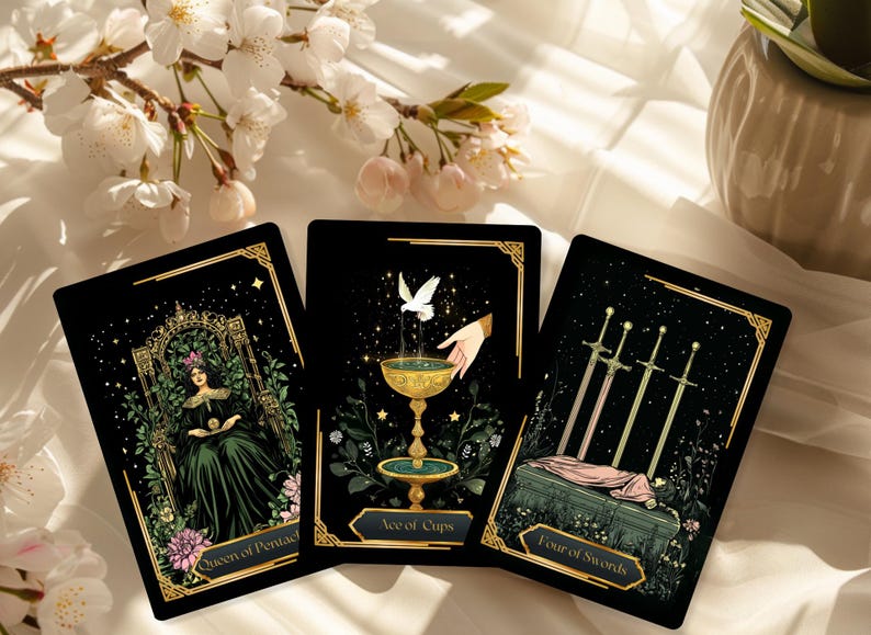 May include: Three tarot cards with black backgrounds and gold borders are displayed. The cards feature detailed illustrations of a queen, a fountain, and four swords. The cards are labeled "Queen of Pentacles", "Ace of Cups", and "Four of Swords".