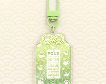 Omamori Kawaii Nyckelring "För att hålla din kopp te gott och varmt tills sista klunken"