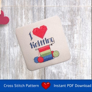 May include: Cross stitch pattern featuring a red heart with the text "I love knitting" and a depiction of knitting needles, yarn, and balls of yarn.