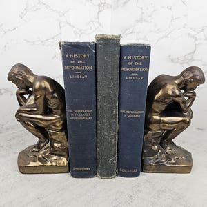 Vintage cast metal &quot;The Thinker&quot; bookends (set of two) | Vintage brass or bronze Rodin sculpture bookends