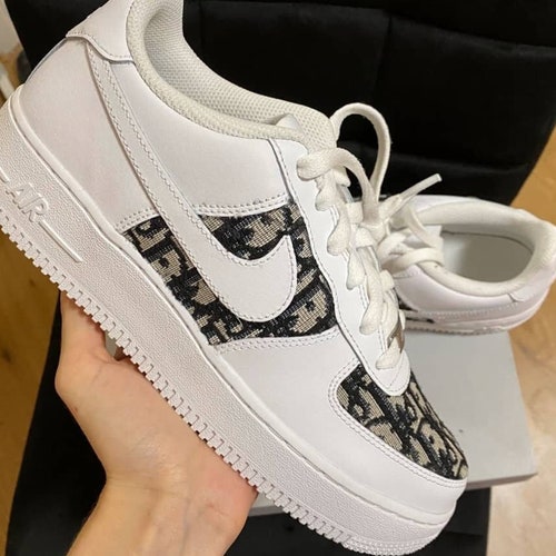 white air forces with gold nike sign