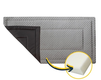 May include: A gray and black quilted pet bed with a removable foam insert. The bed has a textured surface and a black border.