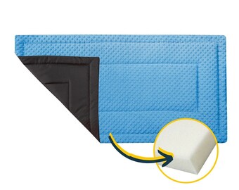 May include: A blue and black quilted pet bed with a foam insert. The bed is designed to provide comfort and support for pets.