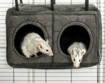May include: Two white rats peek out of two separate openings in a grey hanging rat house with a quilted pattern.