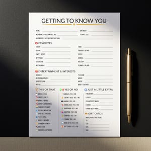 May include: A white questionnaire titled "Getting to Know You" with sections for personal details, favourites, interests, and gift cards. A gold pen lies on the black surface beside the paper. The questionnaire is designed to gather personal information.