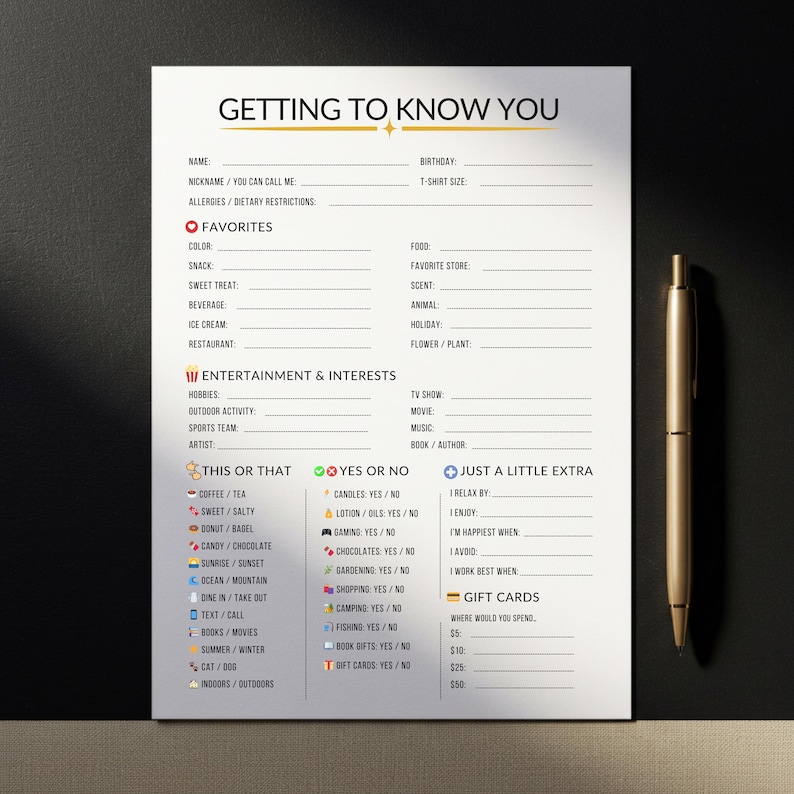 May include: A white questionnaire titled "Getting to Know You" with sections for personal details, favourites, interests, and gift cards. A gold pen lies on the black surface beside the paper. The questionnaire is designed to gather personal information.