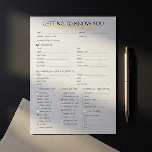 May include: A printed "Getting to Know You" questionnaire on white paper with a gold pen. The form includes sections for favourites, entertainment, and interests. It also has "This or That" and "Yes or No" sections.