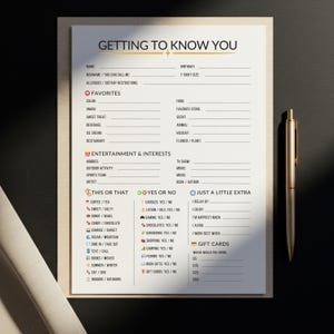 May include: A cream-coloured "Getting to Know You" questionnaire with black text, featuring sections for favourites, interests, and preferences. A gold pen rests on the right side of the page. Ideal for icebreakers.