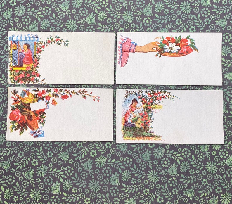 May include: Four vintage blank note cards with floral designs and illustrations of people. The cards are white with a blank space for writing. The floral designs are in shades of pink, red, and green.