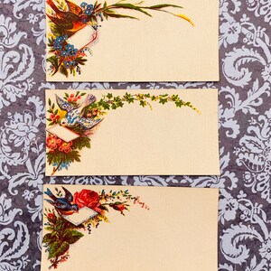 May include: Three vintage blank cards with floral and bird designs. Each card has a blank space for writing. The cards are cream colored with a light yellow tint.
