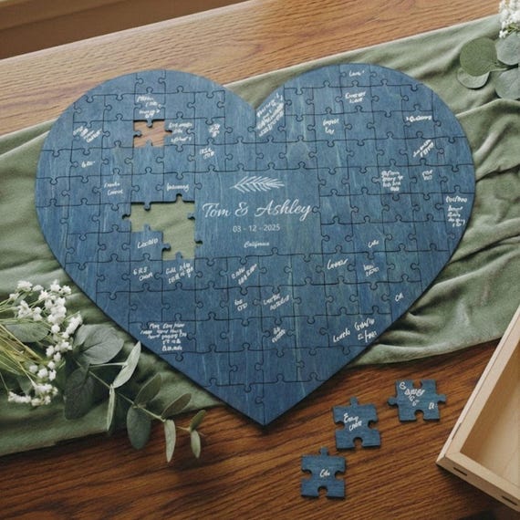 A jigsaw puzzle where wedding guests sign their piece and it assembles into a heart — genuinely clever guestbook alternative with 141 hearts of validation.