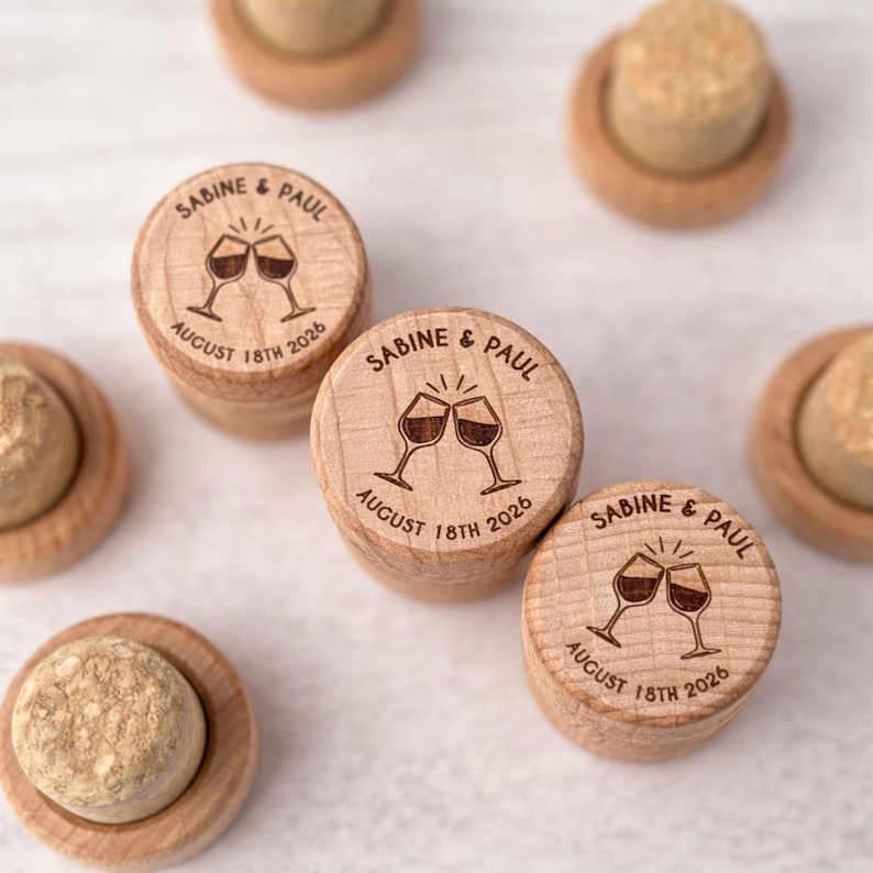 several wooden cork stoppers with engraved text and images, likely representing a couple's wedding or anniversary celebration.