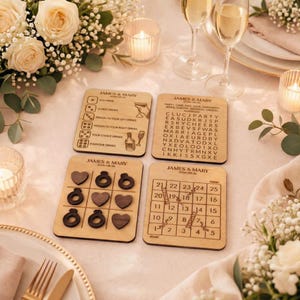 a table setting with four wooden coasters and a tic-tac-toe board, all adorned with elegant floral arrangements and candles.