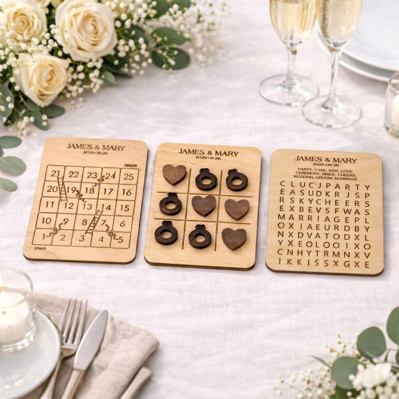 three wooden coasters or game pieces with text and numbers on them, placed on a table with a floral arrangement and wine glasses.