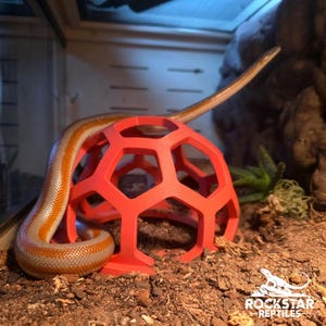 May include: A white ceramic mug with a black handle and the text "But First, Coffee" in a black, handwritten-style font. The mug is on a white surface.