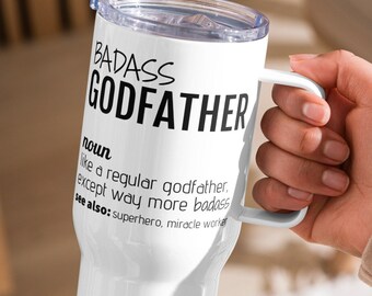 May include: White travel mug with a black inscription that reads "BADASS GODFATHER noun like a regular godfather, except way more badass see also: superhero, miracle worker"