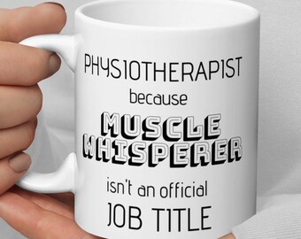 May include: White ceramic mug with black text that reads "Physiotherapist because Muscle Whisperer isn't an official job title."