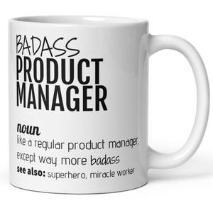 Peut inclure: Mug en céramique blanche avec une anse incurvée. Le mug présente le texte "BADASS PRODUCT MANAGER" en lettres noires en gras. En dessous, le mug indique "noun like a regular product manager, except way more badass see also: superhero, miracle worker."