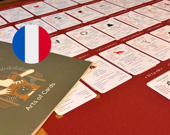 May include: A dark red game board featuring a grid of white cards with French text and small illustrations, accompanied by a dark green booklet titled Arts of Cards. The board displays numbered entries like 27 La lettre and 33 La clé.