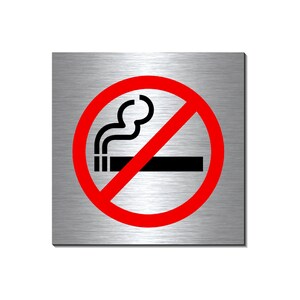 Könnte beinhalten: Ein roter Kreis mit einem diagonalen Strich durch ihn, der das Rauchen verbietet. Das Symbol im Kreis zeigt eine Zigarette mit aufsteigendem Rauch. Das Schild ist auf einem gebürsteten Metalluntergrund.