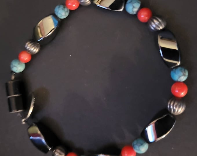 7 1/2 Bracelet stabilized turquoise and red coral set of the design as it is mixed with the black magnetic hematite and silver beads.