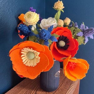 Orange, blue, and red felt bouquet of California poppies, wildflowers, and roses