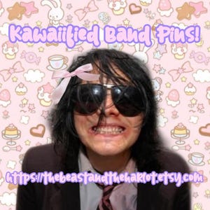 May include: A person wearing sunglasses and a pink bow in their hair is smiling. The background is a pink and white pattern with hearts, stars, and other cute designs. The text "Kawaiified Band Pins!" is at the top of the image. The text "https://thebeastandthechariot.etsy.com" is at the bottom of the image.