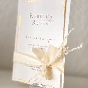 Special boho wedding invitation with torn edges and finished with gold leaf