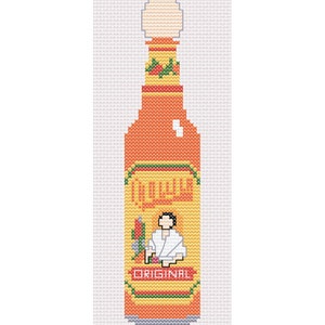 Puede incluir: Una botella de salsa picante roja y amarilla con una tapa blanca. La etiqueta dice "Original" y presenta una caricatura de una persona con un uniforme de chef blanco.