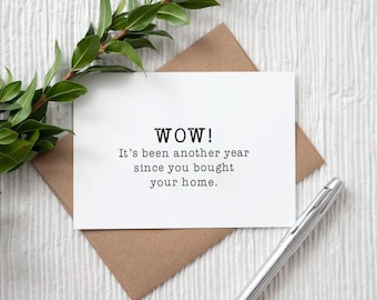 May include: A white card with black text that reads "WOW! It's been another year since you bought your home."